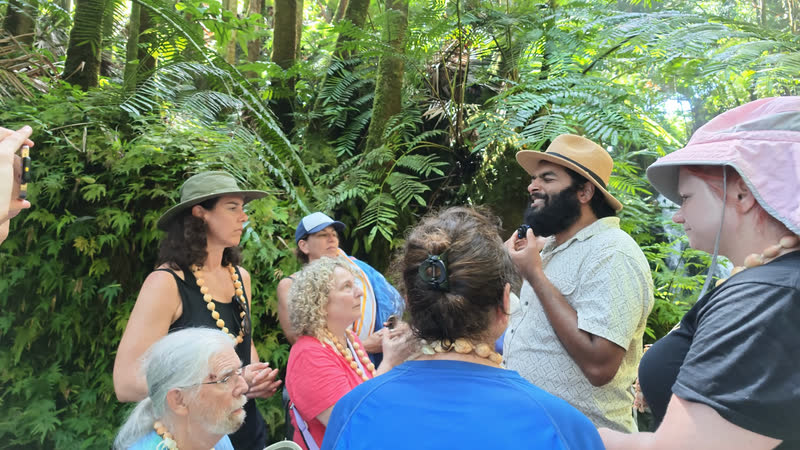 Ra teaching a circle of students in the Hawaiian rainforest